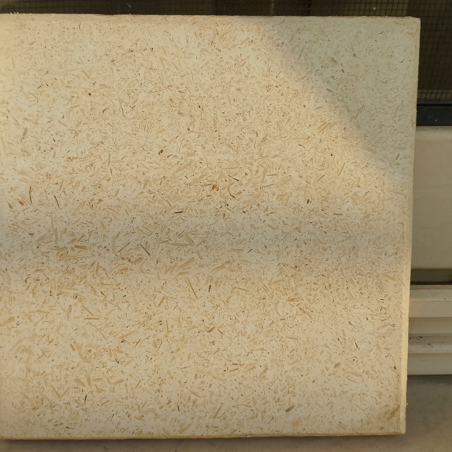 Natural ivory hemp-lime plaster sample with visible fine hemp fibre